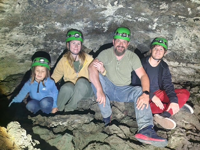 Andrew Fulton exploring a cave with his family
